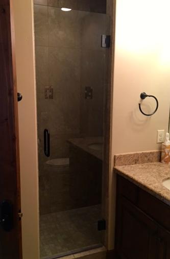 bronze handle frameless glass shower door